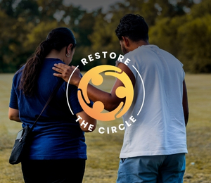 Two people walking together, with the Restore the Circle logo.
